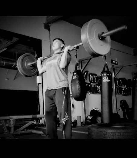 Coach Carlos strength training with a barbell